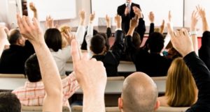 hands raised in a training class