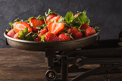complete nutrition strawberries sitting on a scale