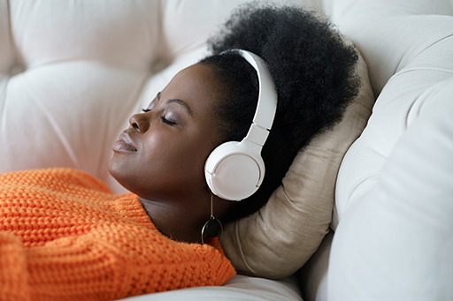 lady wearing headphones meditating for sleep