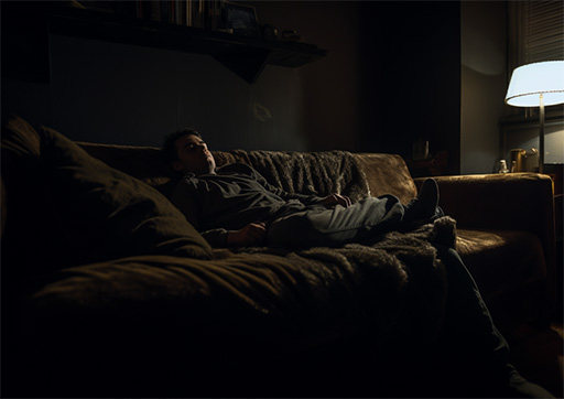 Person relaxing in a dimly lit room