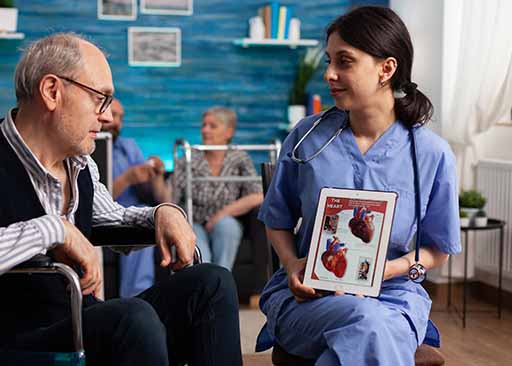 female nurse explaining chronic medical conditions to senior male