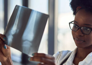 african american lady examining xray during bone mineral density test