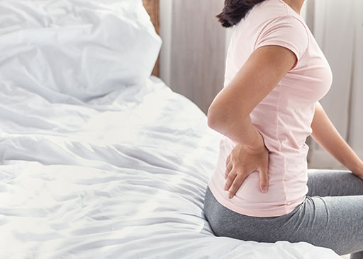 back pain and an old bed is a structural determinants of health example