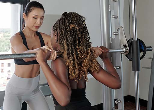 asian coach helping lady with muscle protein synthesis