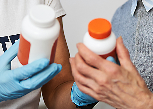 caretaker and elderly lady using medication reconciliation between two options