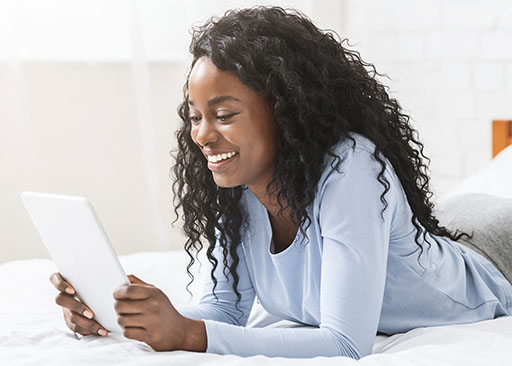 young african american lady reading wellness newsletter on tablet
