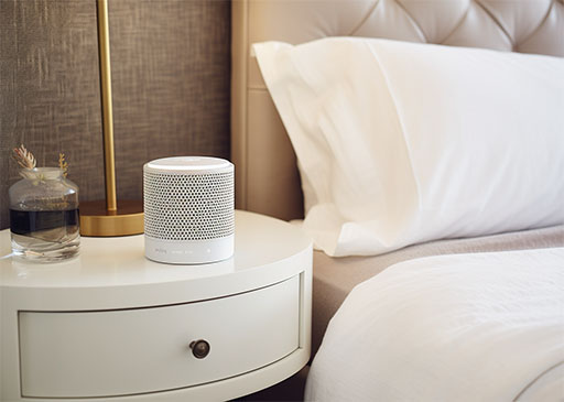 white noise machine on a bedside table