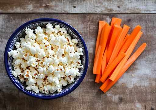 air-popped popcorn and carrot sticks
