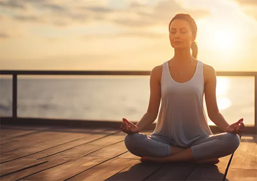 lady meditating near water