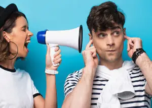 energy vampire using megaphone towards person covering their ears