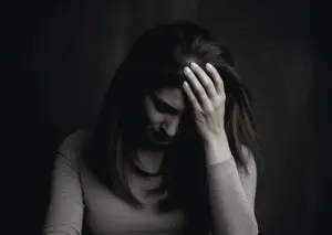 person holding head in pain