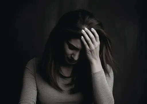 person holding head in pain