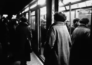 person standing in a crowded subway e1745959416820