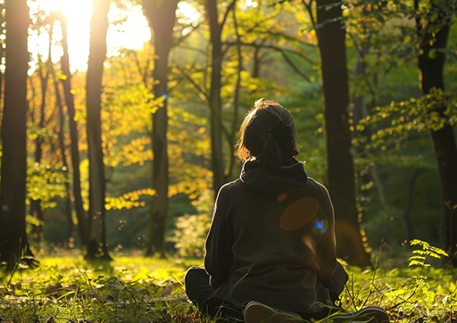 young adult relaxing in a park