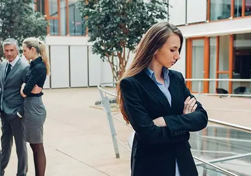 lady standing away from group expressing passive aggressive behavior