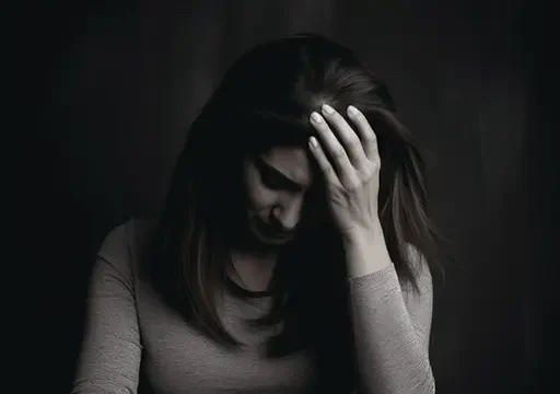 person holding head in pain