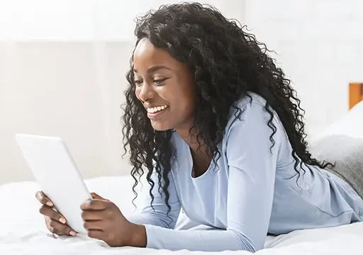 young african american lady reading wellness newsletter on tablet